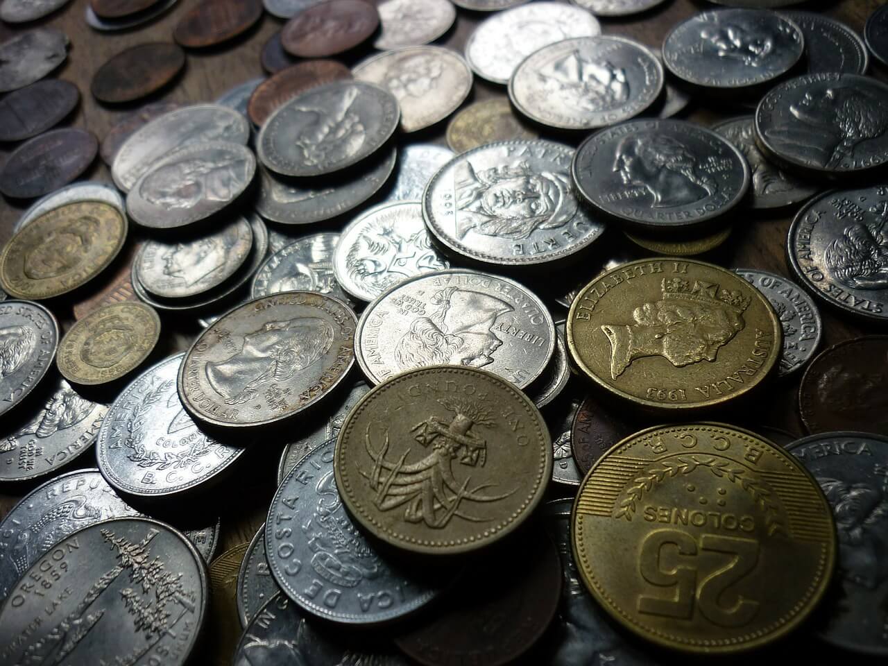 pile of coins from different countries